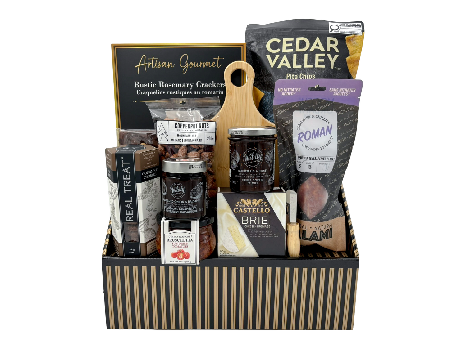 Gourmet gift basket with various food items and packaging on a white background
