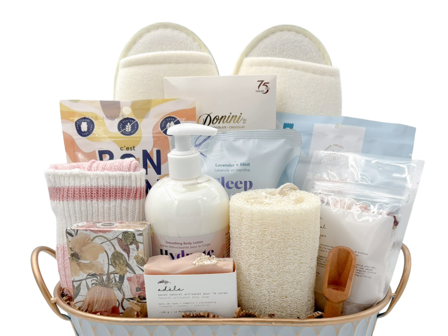 Spa themed gift basket containing sweet treats and indulgent bath products.