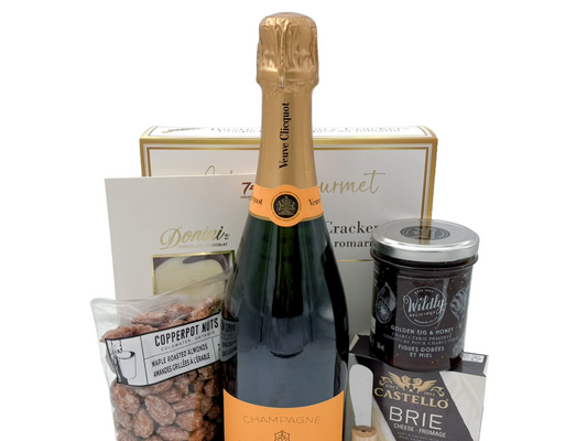 Champagne gift for delivery in Calgary, contains a full size bottle of champagne, crackers, cheese, nuts, chocolate and golden fig honey.  