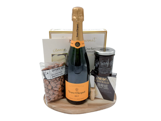 Champagne gift for delivery in Calgary, contains a full size bottle of champagne, crackers, cheese, nuts, chocolate and golden fig honey.  