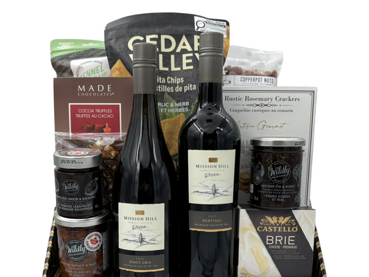 Wine and snacks that pair well with wine in a striped box with a white background 