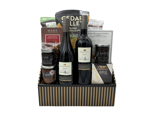Wine and snacks that pair well with wine in a striped box with a white background 