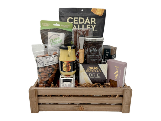 Gift basket with various snacks and cheeses on a white background. Gift basket idea in Calgary.