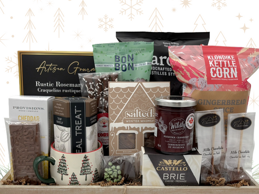 Assorted gourmet food and treat gift set with a mug and various products on a decorative background.