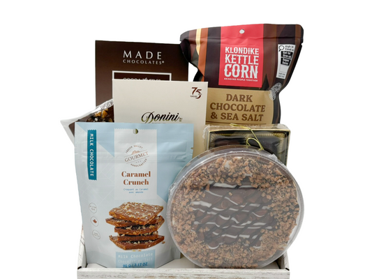 gift box with chocolates and other sweet snacks on a white background.