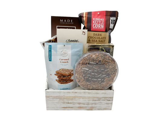 gift box with chocolates and other sweet snacks on a white background.