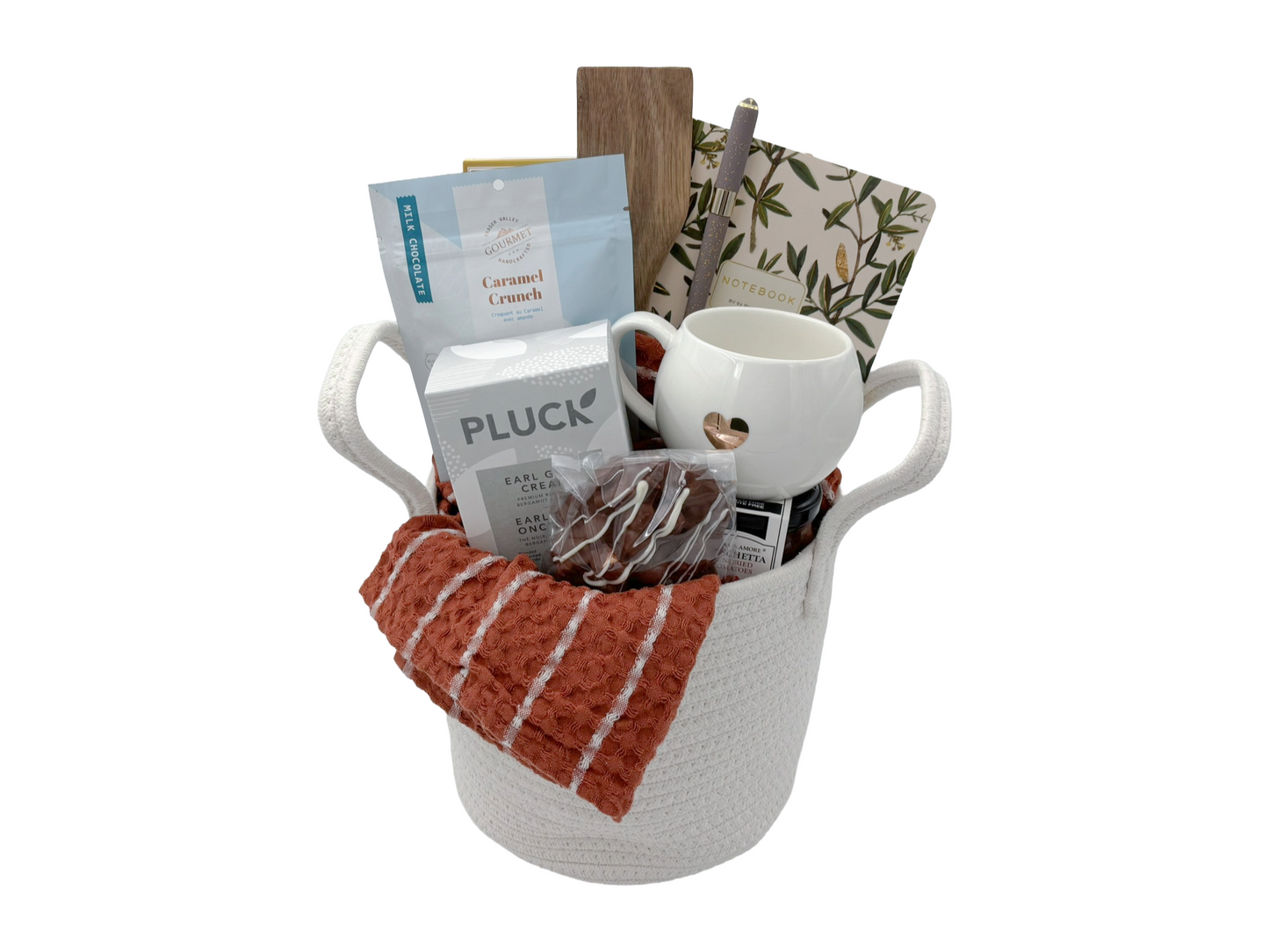 Gift basket with coffee mug, snacks, and tea bags on a white background