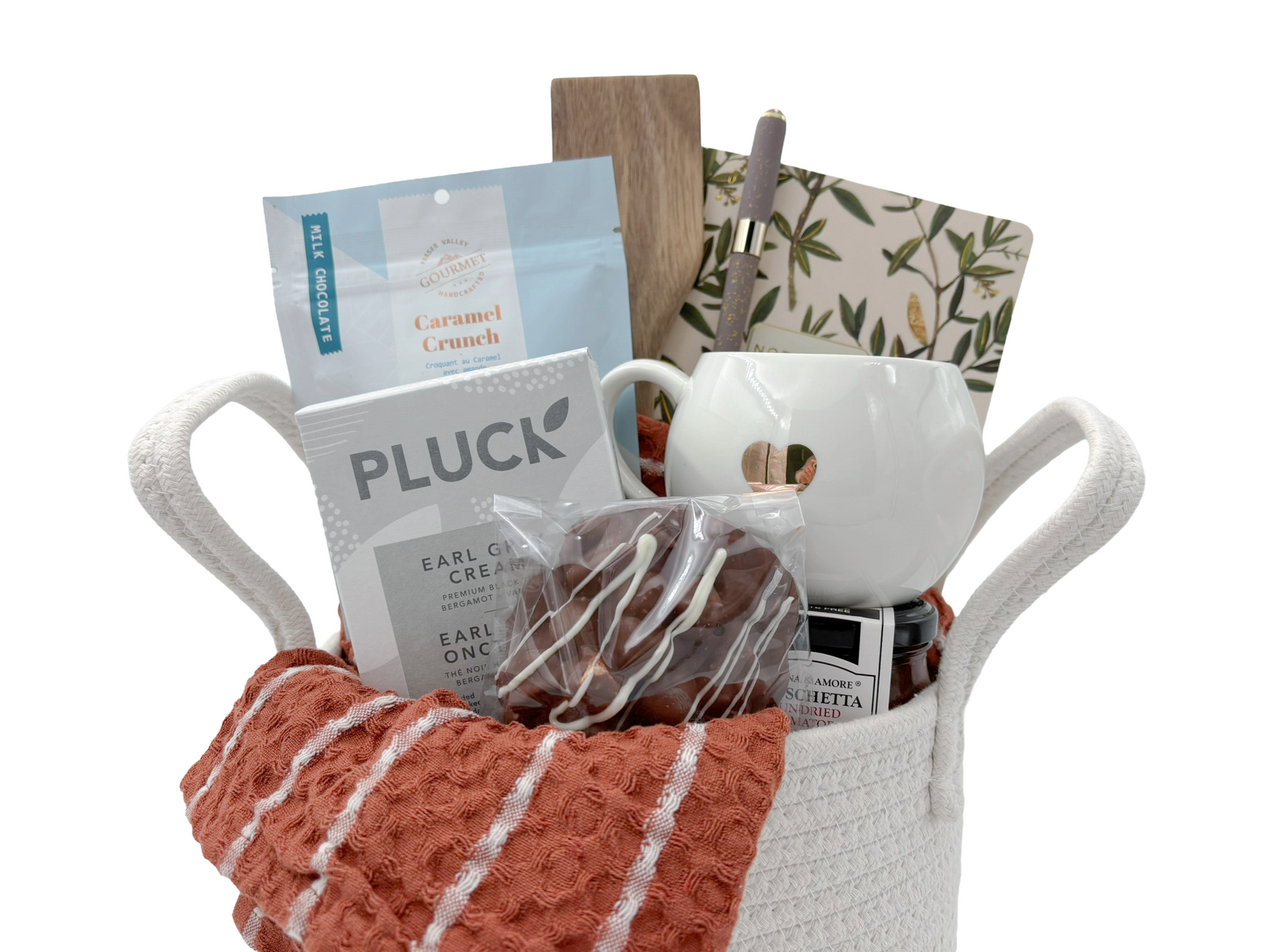 Gift basket with a mug, snacks, and a blanket on a white background