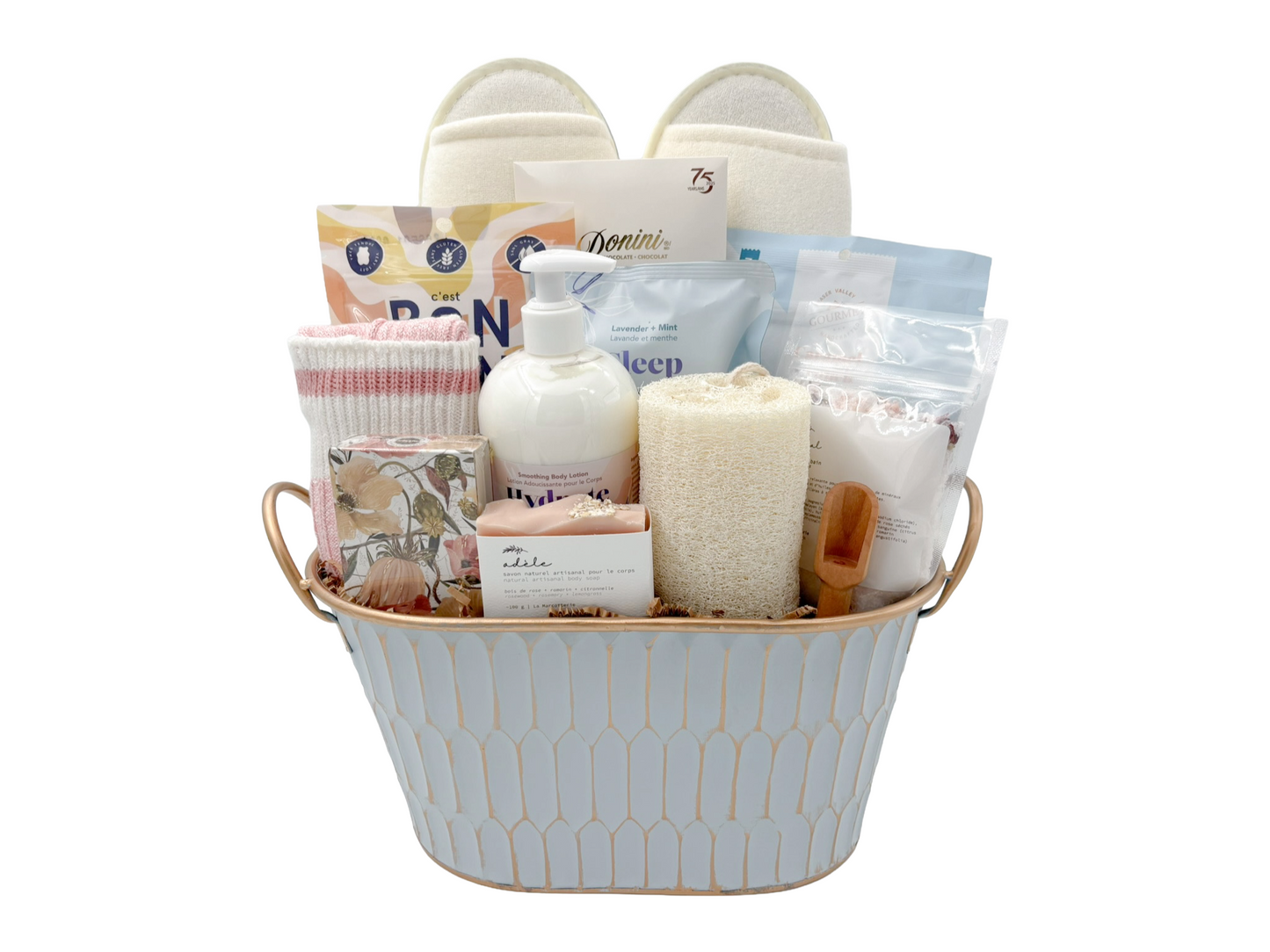 Spa themed gift basket containing sweet treats and indulgent bath products.